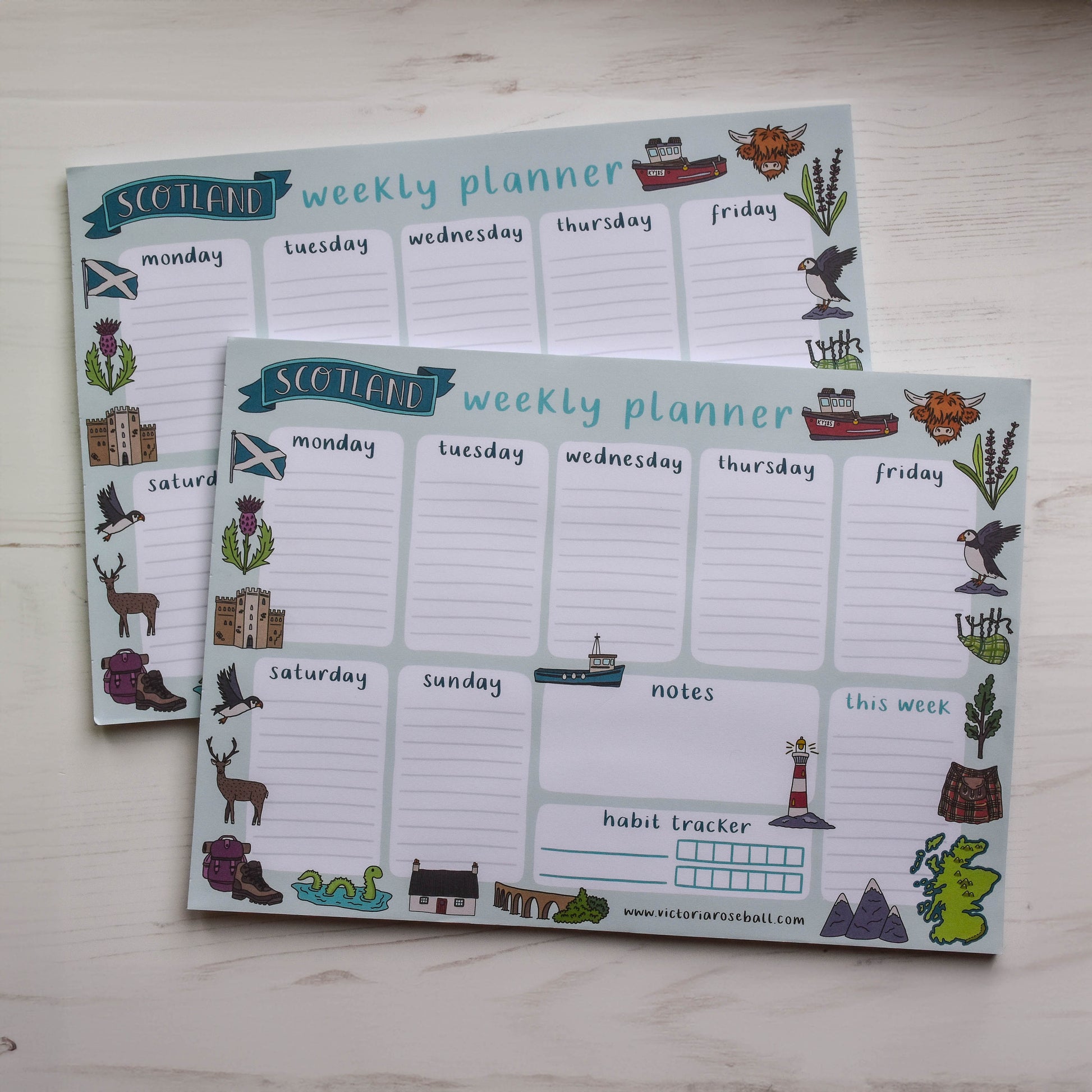 Two Scottish-themed weekly planners on a wooden surface