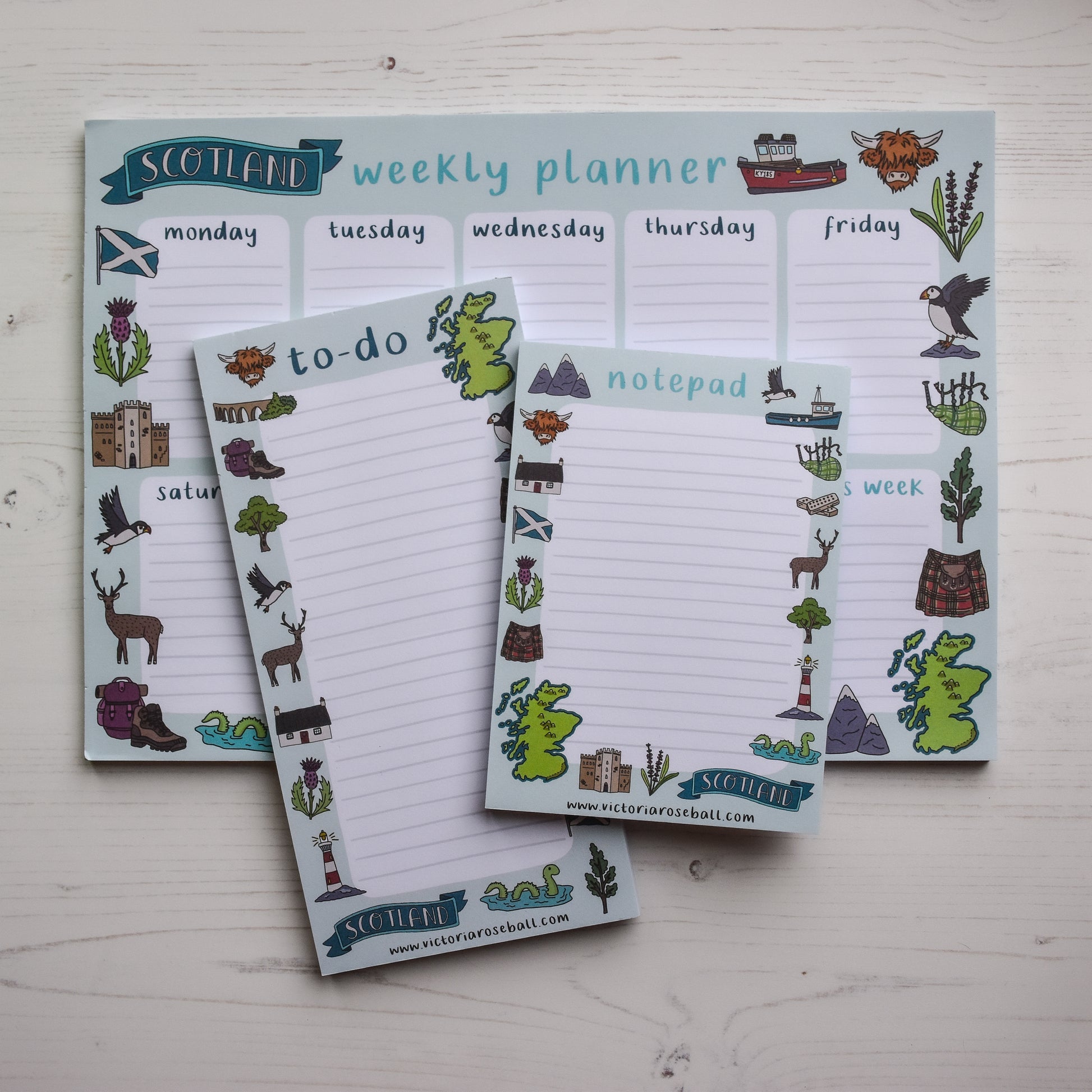 Set of Scottish-themed stationery items including a weekly planner, to-do list, and notepad on a light wooden surface.